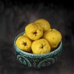 Still life of quinces in a turquoise bowl with Persian calligraphy – part of the Faces of Resilience series by Masoud Teimory