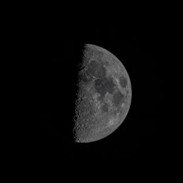Detailed image of the Moon's first quarter phase showing crater textures along the shadow line