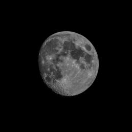 High-contrast image of the waxing gibbous Moon with visible craters and maria